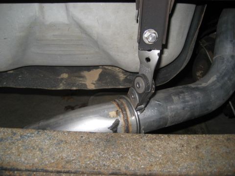 1996 Ford Bronco - Close-up view of an exhaust pipe clamp attached to a vehicle's undercarriage.
