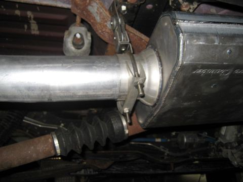 1996 Ford Bronco - Underside view of a vehicle's exhaust system, showing a new muffler installation.