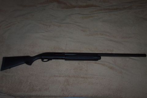 1994 Ford F-150 - A black shotgun is displayed horizontally on a patterned background.