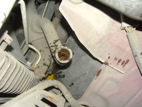 2007 Ford Mustang - Close-up of a corroded heater core hose connection, showing signs of fluid leakage.