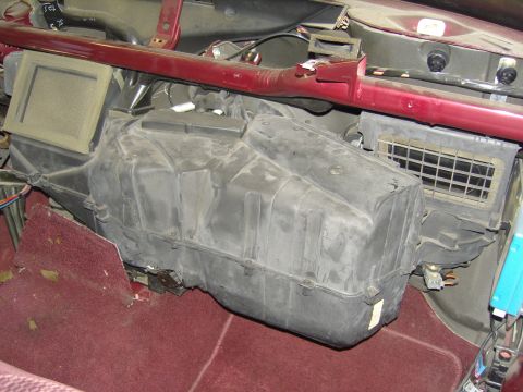 2007 Ford Mustang - Interior teardown with the dashboard removed, showing the black plastic HVAC heater/evaporator case still mounted against the firewall abov…