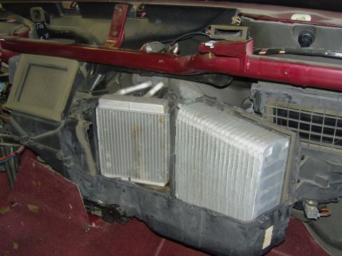 2007 Ford Mustang - Close-up of a vehicle's HVAC box with the dash removed, showing the exposed heater core (left) and the finned A/C evaporator core (right) i…
