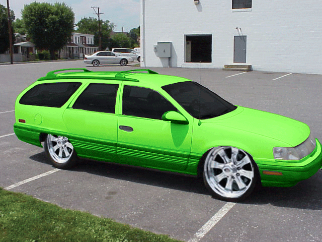 Lime green station wagon with custom wheels, side view