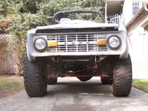 1973 Ford Bronco - Front view of a gray 1973 Ford Bronco with prominent "FORD" lettering on the grille.