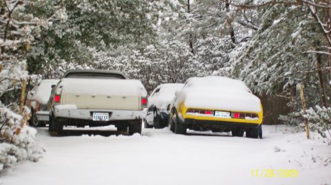 1972 Ford Ranchero - Three vehicles, including a 1972 Ford Ranchero, sit covered in snow.