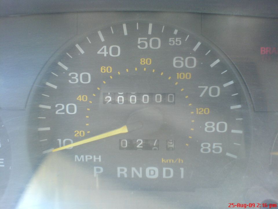 Analog speedometer with odometer reading 200,000 miles and P R N D 1 display
