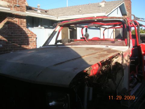 1985 Ford Bronco - This vehicle, possibly undergoing a rebuild, features a prominent red roll cage and a partially covered front end, with the date 11.29.2009…