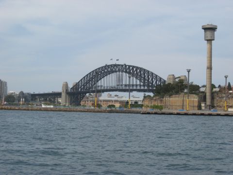 2008 Ford F-250 - View of the iconic Sydney Harbour Bridge and a tall tower structure on a cloudy day.