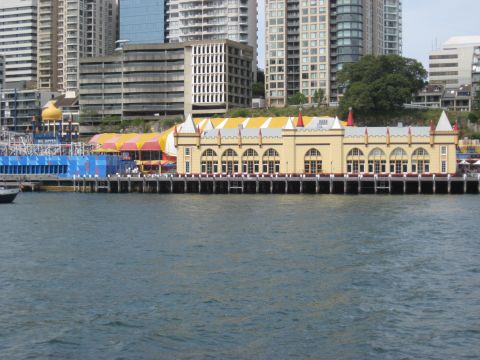 2008 Ford F-250 - A view of waterfront buildings with distinctive architecture and colorful awnings, set against a backdrop of city skyscrapers.
