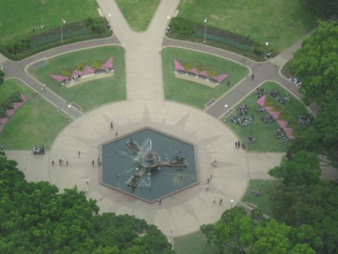 2008 Ford F-250 - A wide shot captures a bustling park scene from above, complete with a central fountain and surrounding green spaces.