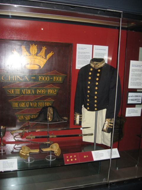 2008 Ford F-250 - A museum exhibit showcases a naval uniform, hat, swords, and a plaque detailing service in China, South Africa, and World War I.