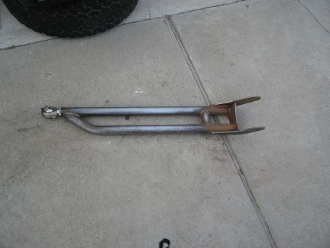 1986 Ford Bronco - A single radius arm suspension part, likely for an off-road vehicle, is shown on a concrete surface.