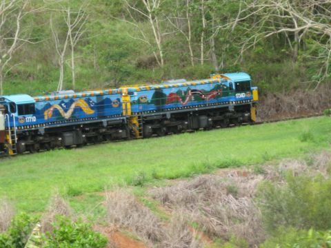 2008 Ford F-250 - Two locomotives decorated with vibrant dragon artwork travel along a railway line surrounded by lush greenery.