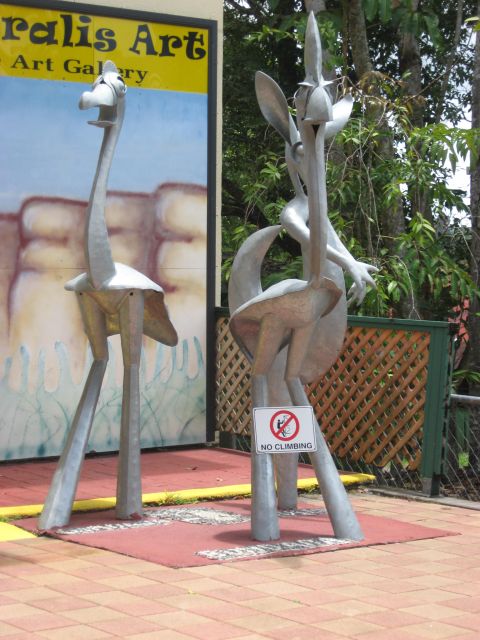 2008 Ford F-250 - Metal sculptures of cartoon animals are displayed outside an art gallery, with a 'No Climbing' sign posted.