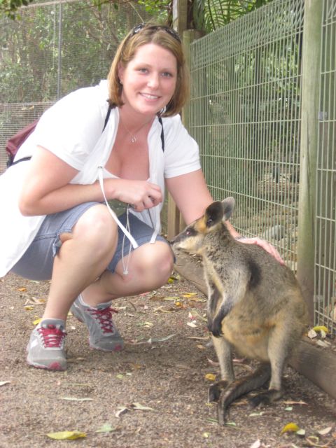 2008 Ford F-250 - A woman interacts with a wallaby in a fenced area, possibly a zoo or wildlife park.