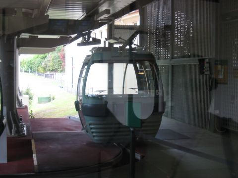 2008 Ford F-250 - A cable car is parked at a station, ready for passengers. The vehicle has a distinctive green and white color scheme.