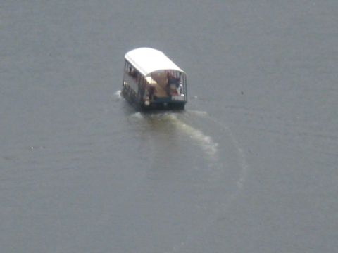 2008 Ford F-250 - A tour boat navigates through the water, creating a visible wake behind it.
