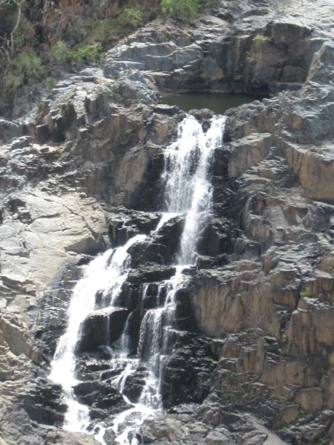 2008 Ford F-250 - A scenic view of a waterfall flowing down a , rocky mountainside.