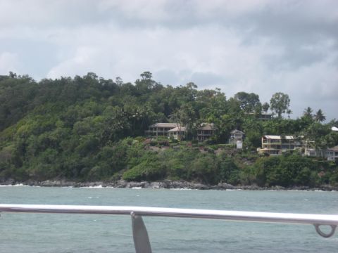 2008 Ford F-250 - Several homes are visible on a densely wooded hillside overlooking a body of water.