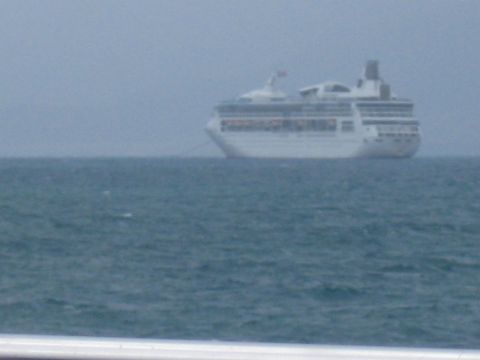 2008 Ford F-250 - A large white cruise ship is visible on the water with a hazy sky above.
