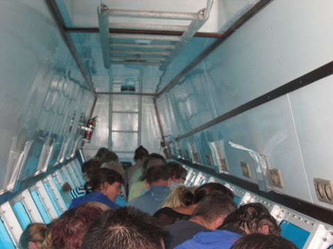 2008 Ford F-250 - The interior of a vehicle is packed with people, suggesting it is a form of transport.
