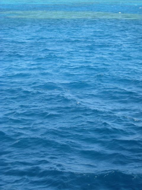 2008 Ford F-250 - The vast expanse of blue ocean water stretches to the horizon, with a hint of a reef beneath the surface.