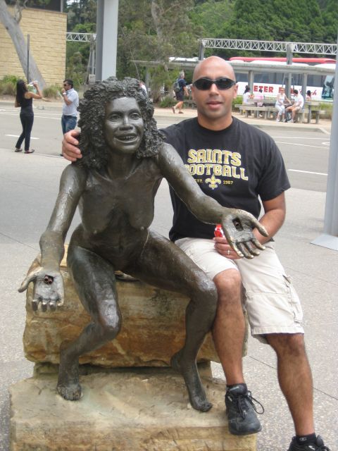 2008 Ford F-250 - Man poses with a bronze statue of a woman outdoors, with other people and a bus in the background.