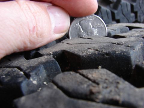 1984 Ford F-250 - Measuring tire tread depth with a quarter coin.