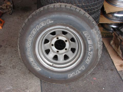 1984 Ford F-250 - A single tire and rim assembly is shown, with visible text on the tire's sidewall.