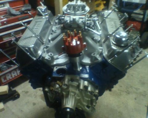 1982 Ford F-100 - A V8 engine with chrome valve covers and a red distributor cap is shown, with "351" visible on one of the valve covers.