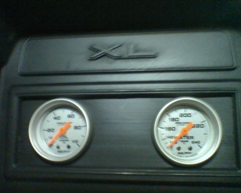 1982 Ford F-100 - The interior of a 1982 Ford F-100 shows oil and water temperature gauges along with an XL trim badge.