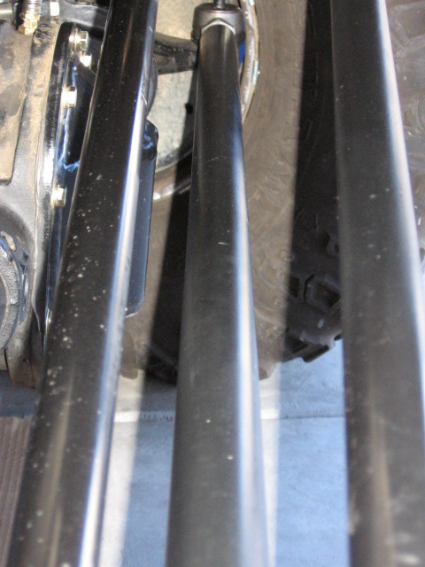 1995 Ford Bronco - Close-up view of vehicle suspension components and a tire.