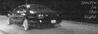 1999 Ford Taurus - A dark sedan is captured in motion on a road at night, with text overlayed on the image.