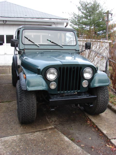 1979 Jeep CJ7 - Front view of a green 1979 Jeep CJ7 parked in a driveway.
