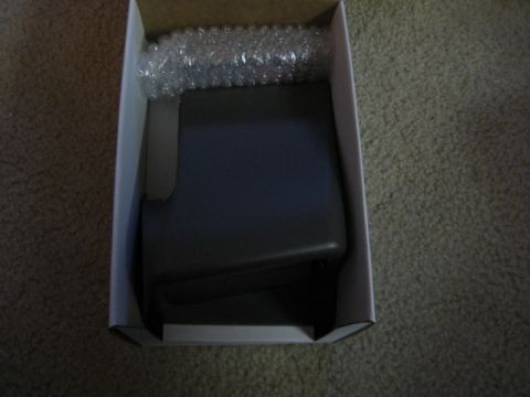2004 Ford F-150 - A car part is shown inside a box, with bubble wrap cushioning.