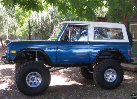 1977 Ford Bronco - This 1977 Ford Bronco is shown from the side, a lifted suspension and aggressive off-road tires.