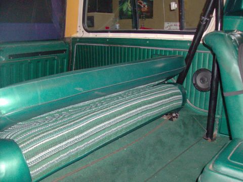 1978 Ford Bronco - Interior view of a vintage SUV, highlighting the green striped rear bench seat and matching door panels.