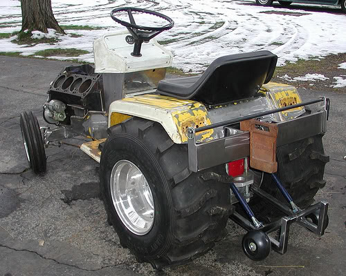 Custom tractor with exposed V8 engine and large rear tires