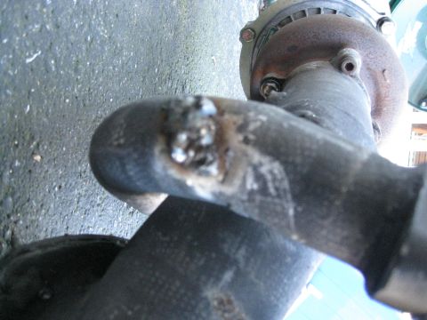 1994 Ford Probe - Close-up of a damaged exhaust pipe section with a bolted flange, showing evidence of welding repairs.