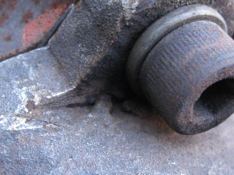1994 Ford Probe - Close-up of a corroded metal component, possibly from a vehicle's engine or suspension system, a hexagonal recess. The image includes a Sup…