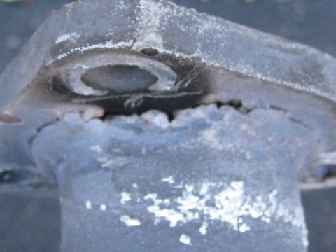 1994 Ford Probe - This image shows a close-up of a worn and corroded metal automotive part.