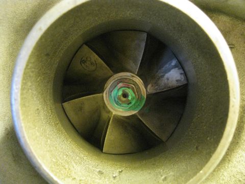 1994 Ford Probe - Close-up view of a turbocharger's compressor wheel, showing its blades and a central nut with green discoloration.