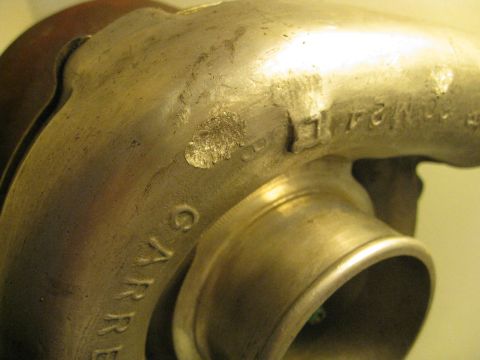 1994 Ford Probe - This is a close-up view of a Garrett turbocharger housing with stamped markings.