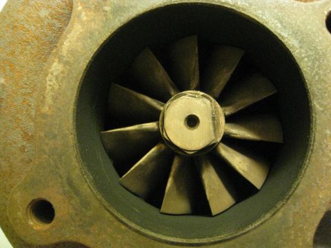 1994 Ford Probe - Close-up view of a turbocharger's compressor wheel, showing its intricate blade design and central fastening mechanism.