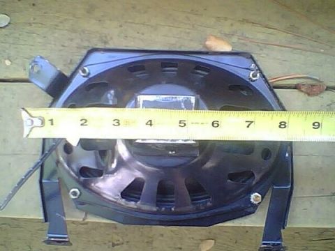 1972 Ford Ranchero - A speaker is measured with a tape measure, indicating its size.