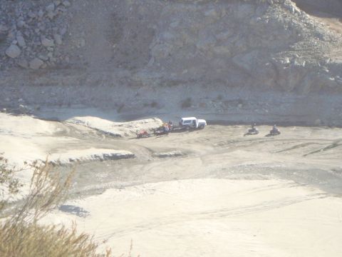 1986 Ford Bronco - A white SUV and several ATVs are seen in a dry, rocky outdoor area, with a watermark for Supermotors.net visible.