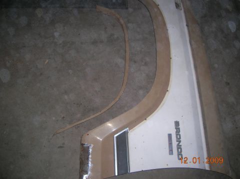 1985 Ford Bronco - Close-up of a Ford Bronco XLT fender trim piece, showing the model name and a date stamp.