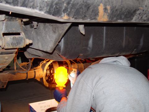 1993 Ford Bronco - Working on the rear differential, with a box of parts nearby.
