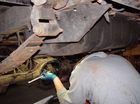 1993 Ford Bronco - Mechanic works on the rear axle differential of a 1993 Ford Bronco.