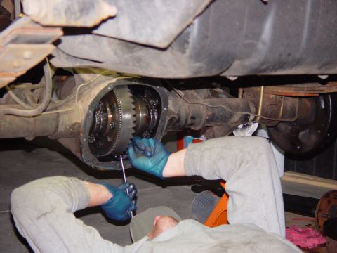 1993 Ford Bronco - A mechanic performs a rear axle differential rebuild, focusing on the gears and internal components.